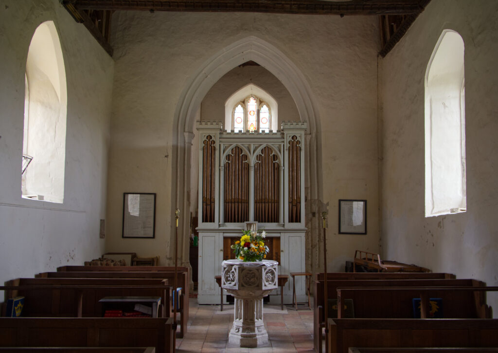 A font and small organ in a church