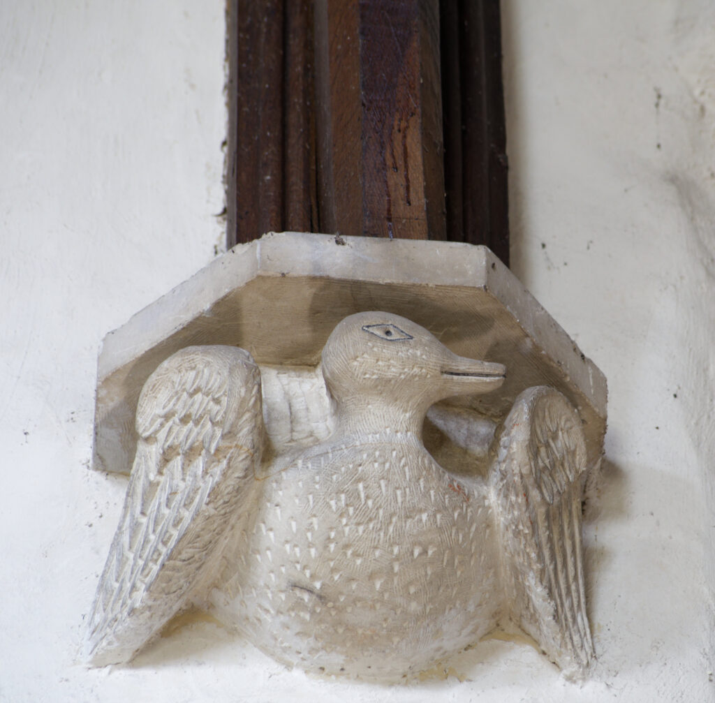 A relief sculpture of a duck on the church wall