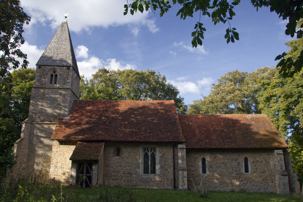 The outside of Chickney church, with deep shadows
